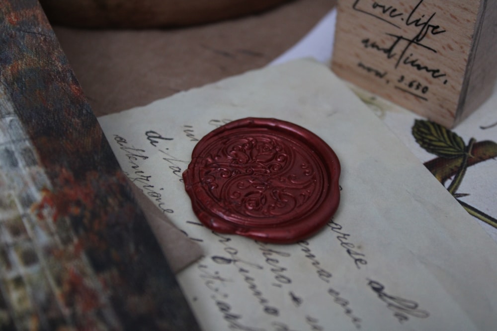 a wax stamp sitting on top of a piece of paper