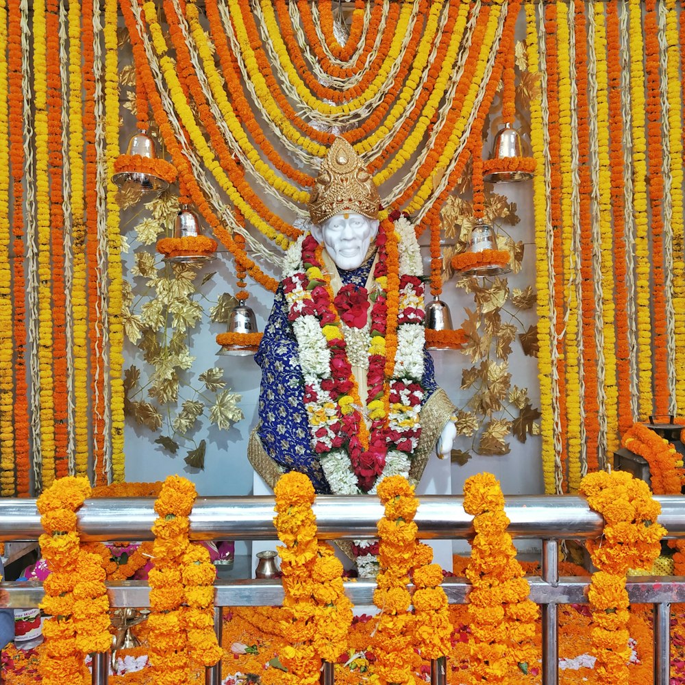 a statue of a person surrounded by flowers