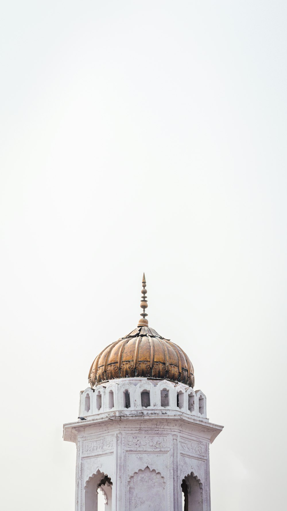 a white building with a golden dome on top