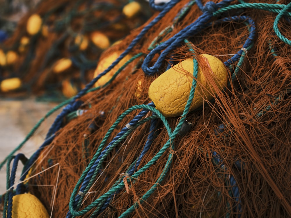 a pile of fishing nets with yellow and blue ropes