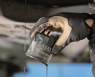 a mechanic is pouring oil on a car