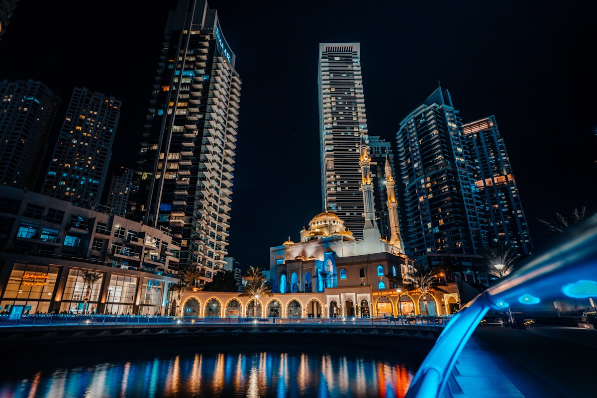 Dubai October — Dubai Marina glowing with lights and tower reflections in the canal at night