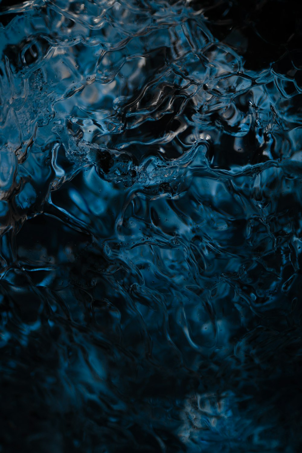 a close up of water with a black background