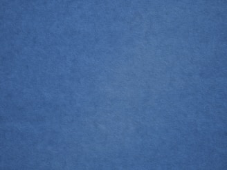 an airplane is flying in the blue sky