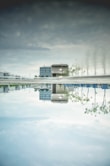 a reflection of a building in a pool of water