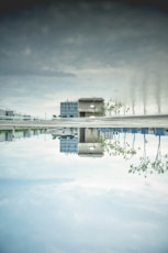 a reflection of a building in a pool of water