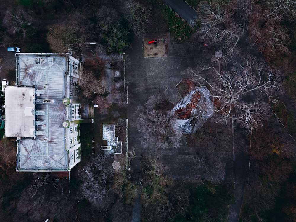 an aerial view of a house surrounded by trees