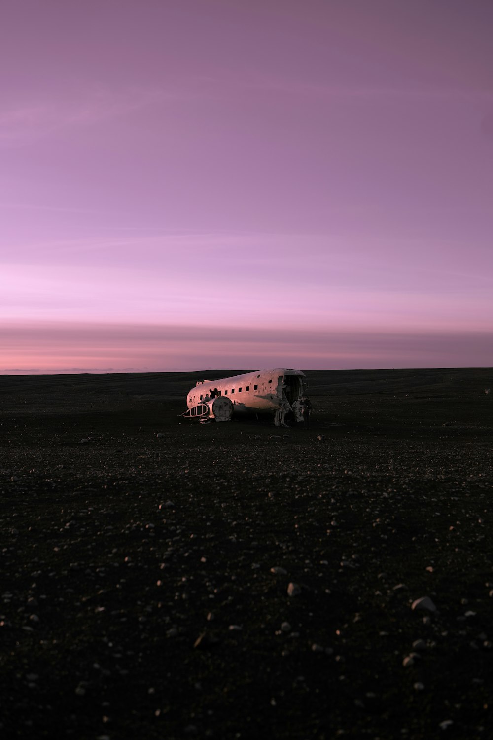 a small airplane sitting on top of a dry grass field