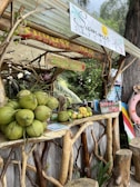 a fruit stand with coconuts, bananas, and a life preserver