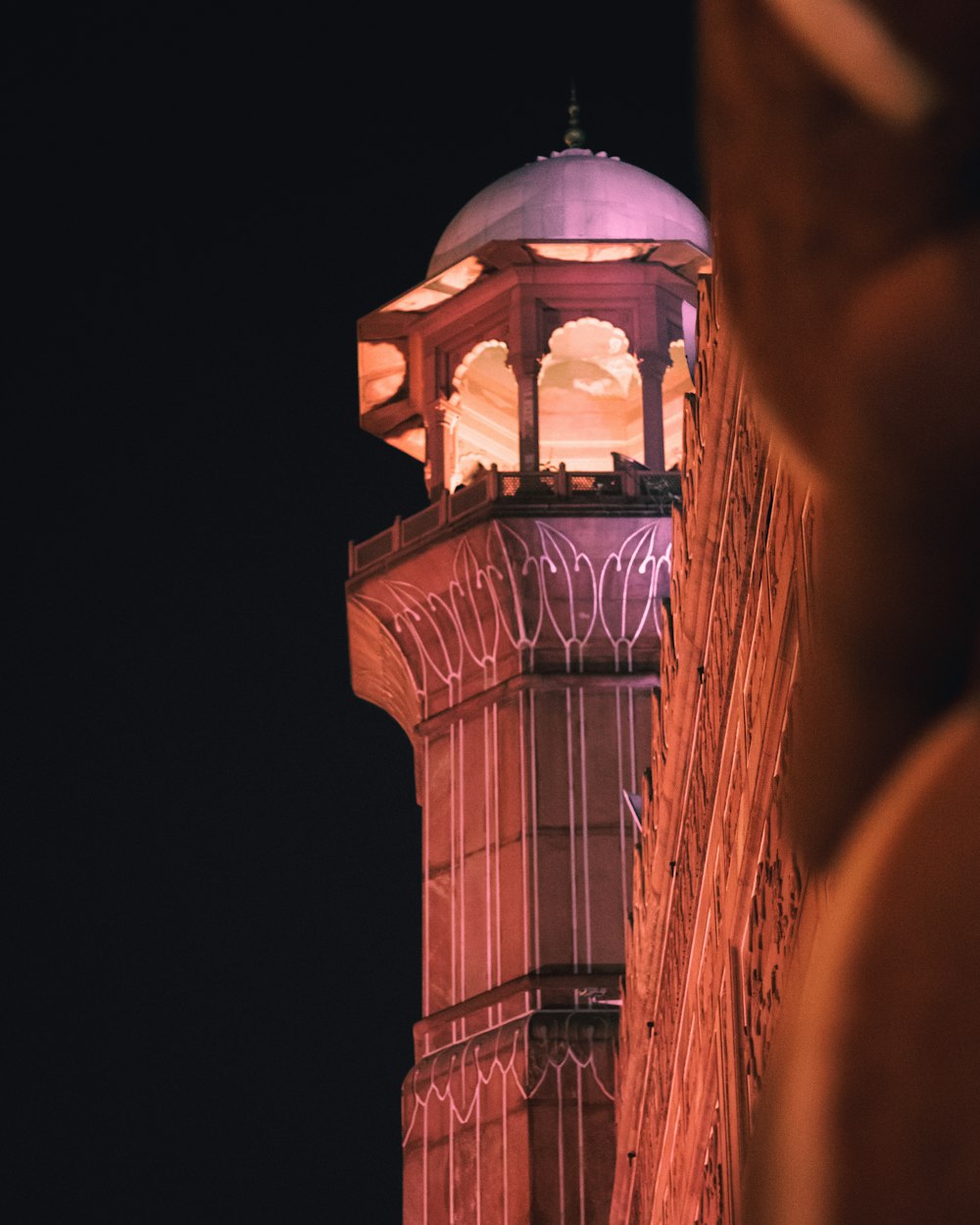 a tall tower with a clock on it's side