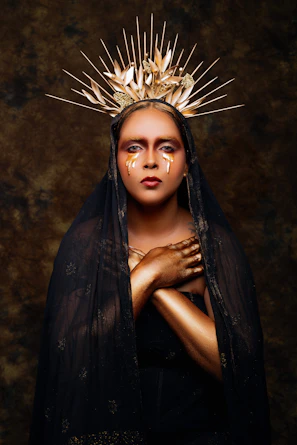 Artistic portrait of a model wearing fashion pieces inspired by Viking armor and Egyptian motifs.