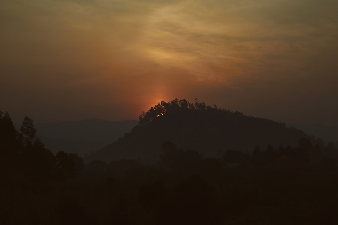 the sun is setting over a mountain range, Sunset in the land of a thousand hills. Taken during our trip to East Africa i