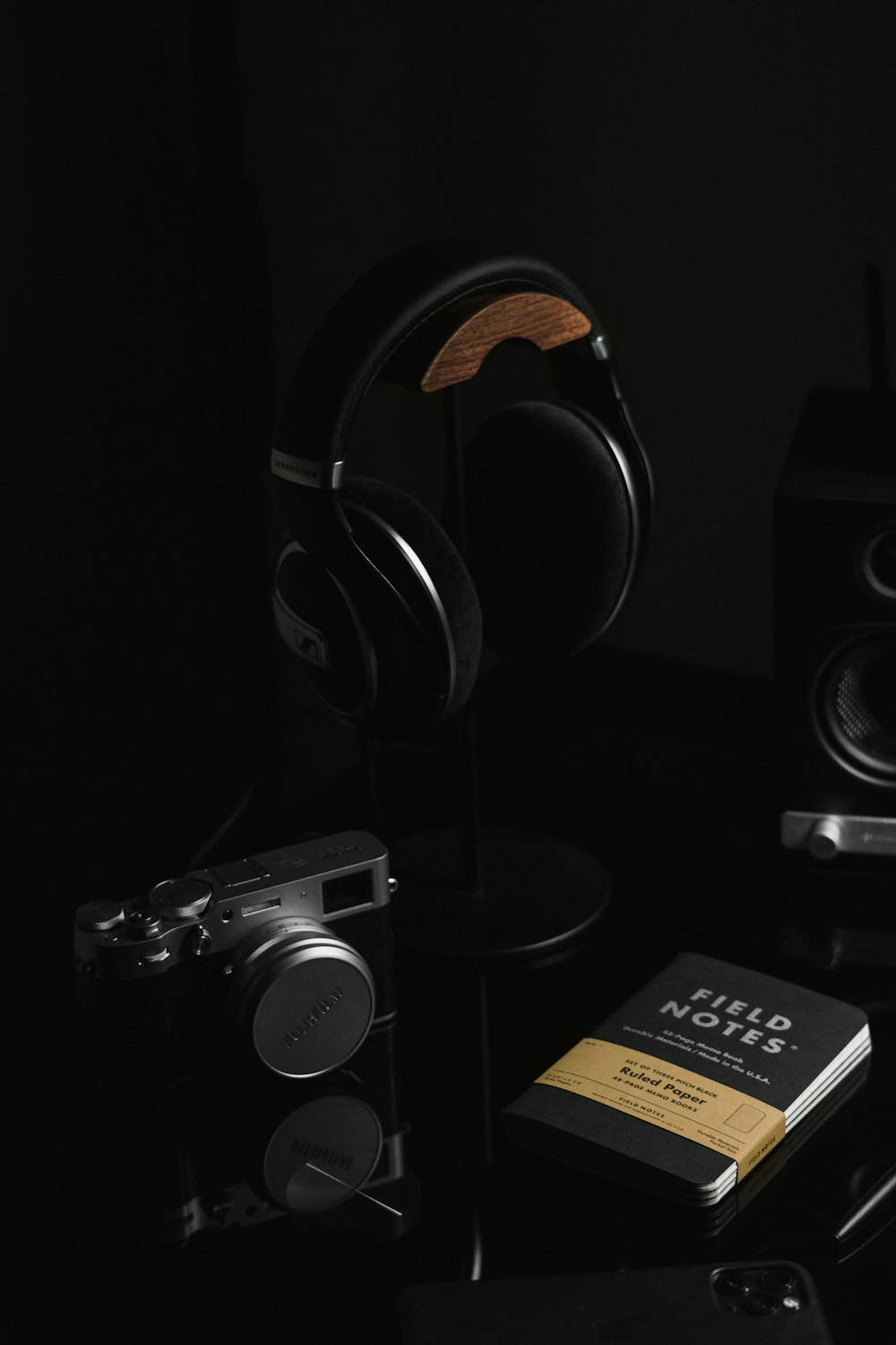 a black table with headphones and a book