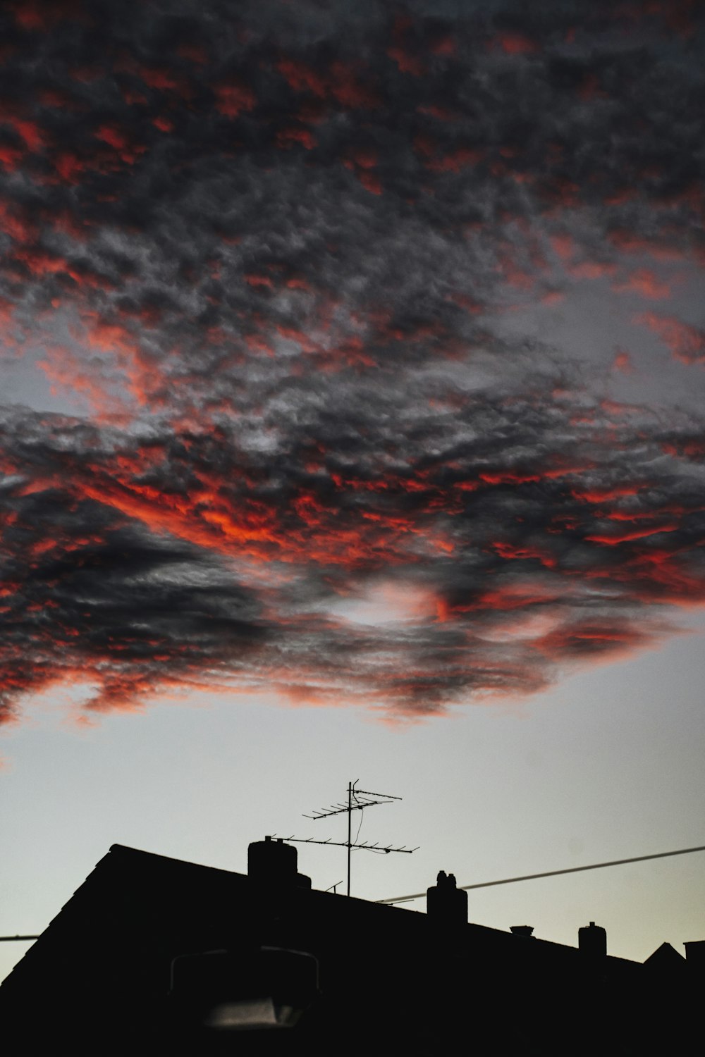 a red cloud is seen in the sky above a building