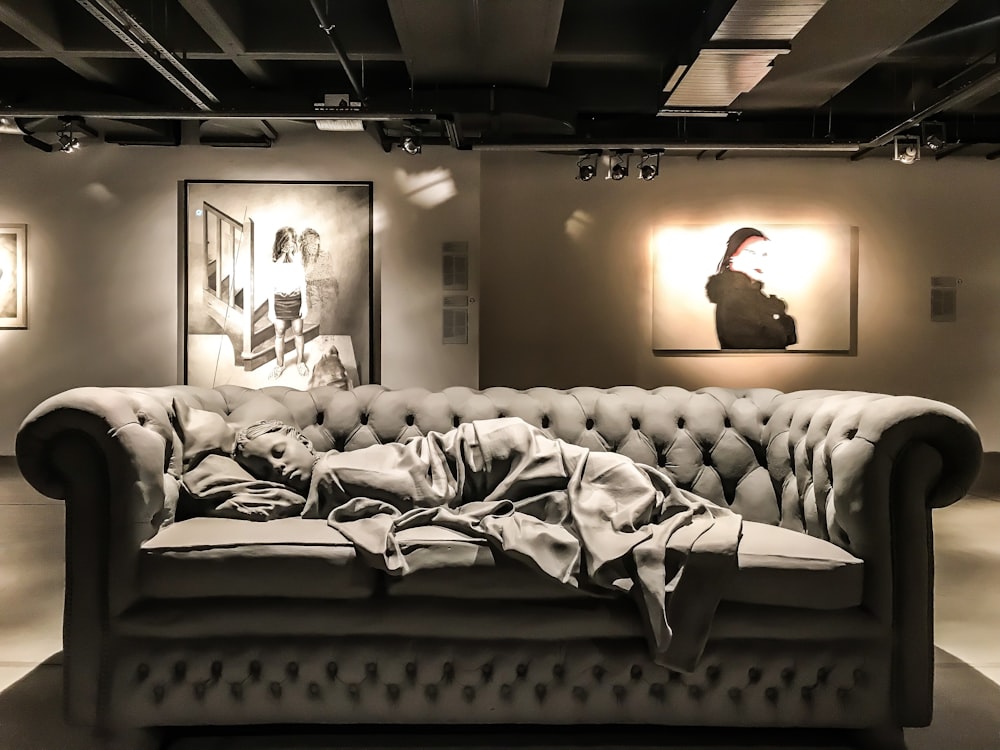 a black and white photo of a couch with a blanket on it