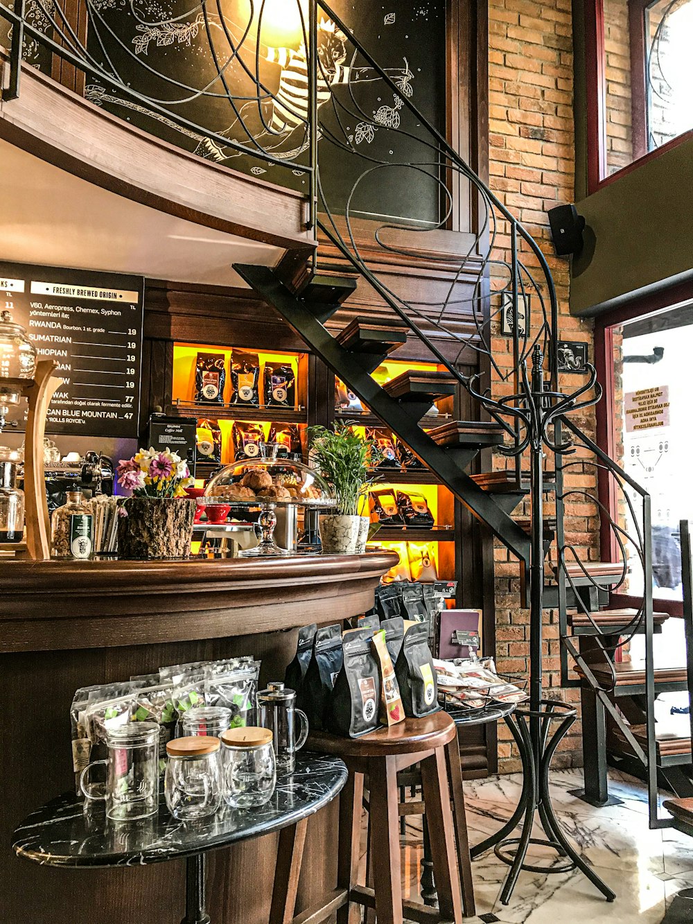 a restaurant with a spiral staircase and a bar