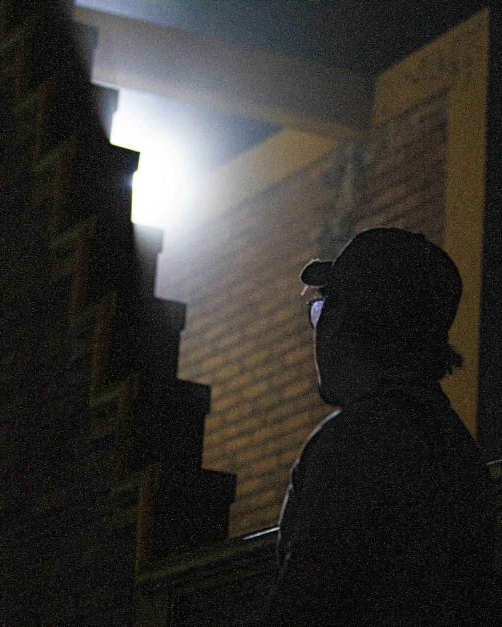 a person standing in front of a building at night