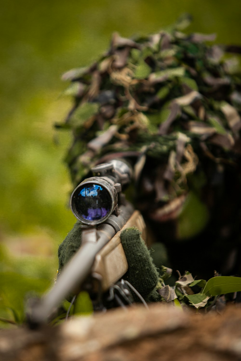 a close up of a toy gun with a camouflage hat on it