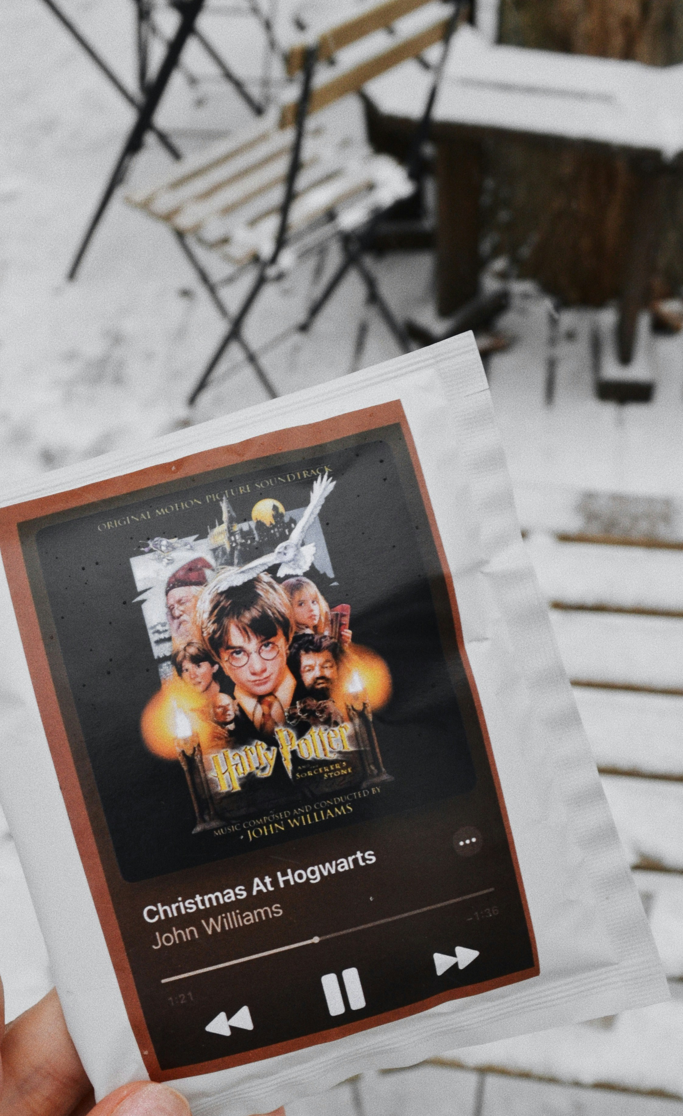 a person holding up a piece of paper with a movie poster on it
