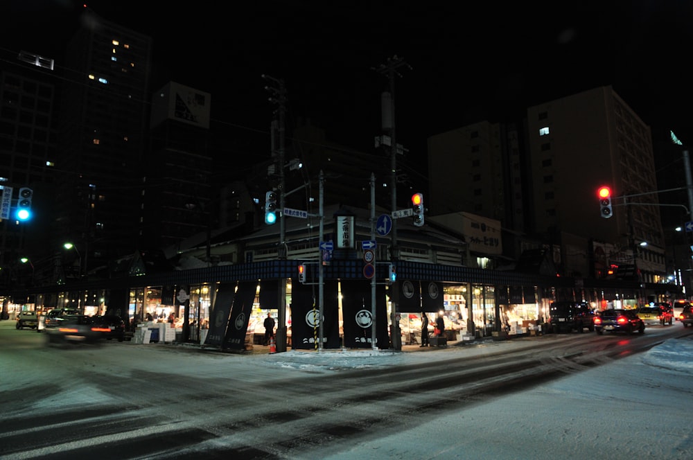 a city street at night with traffic lights