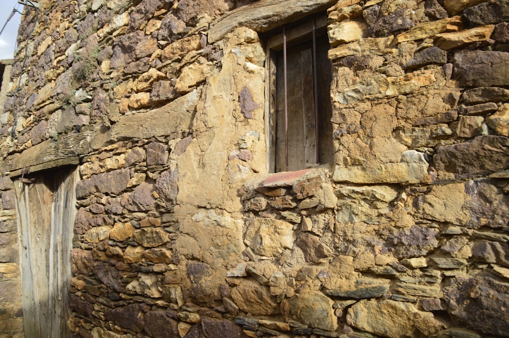 a stone building with a window and a door