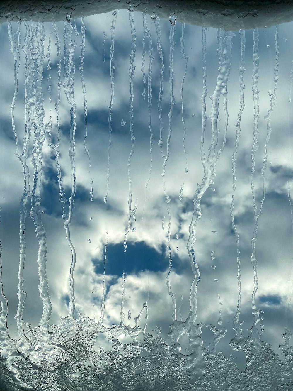 a view of a cloudy sky through a window