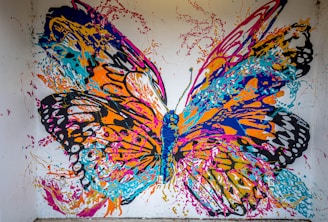a painting of a colorful butterfly on a white wall