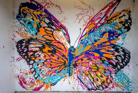 a painting of a colorful butterfly on a white wall