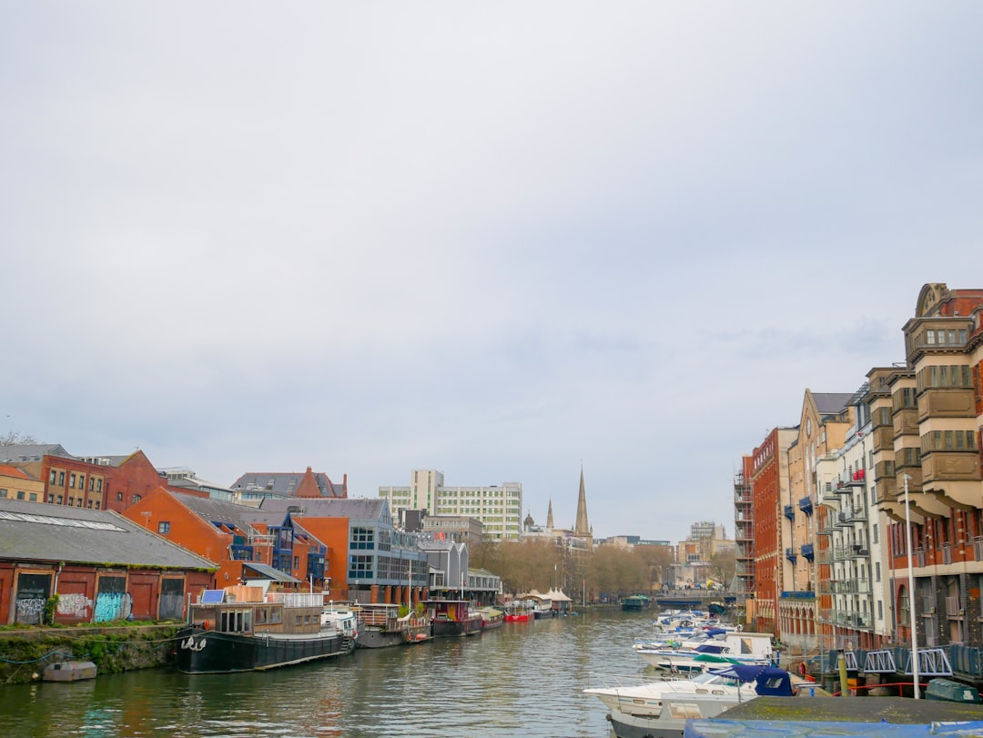 a river running through a city next to tall buildings,