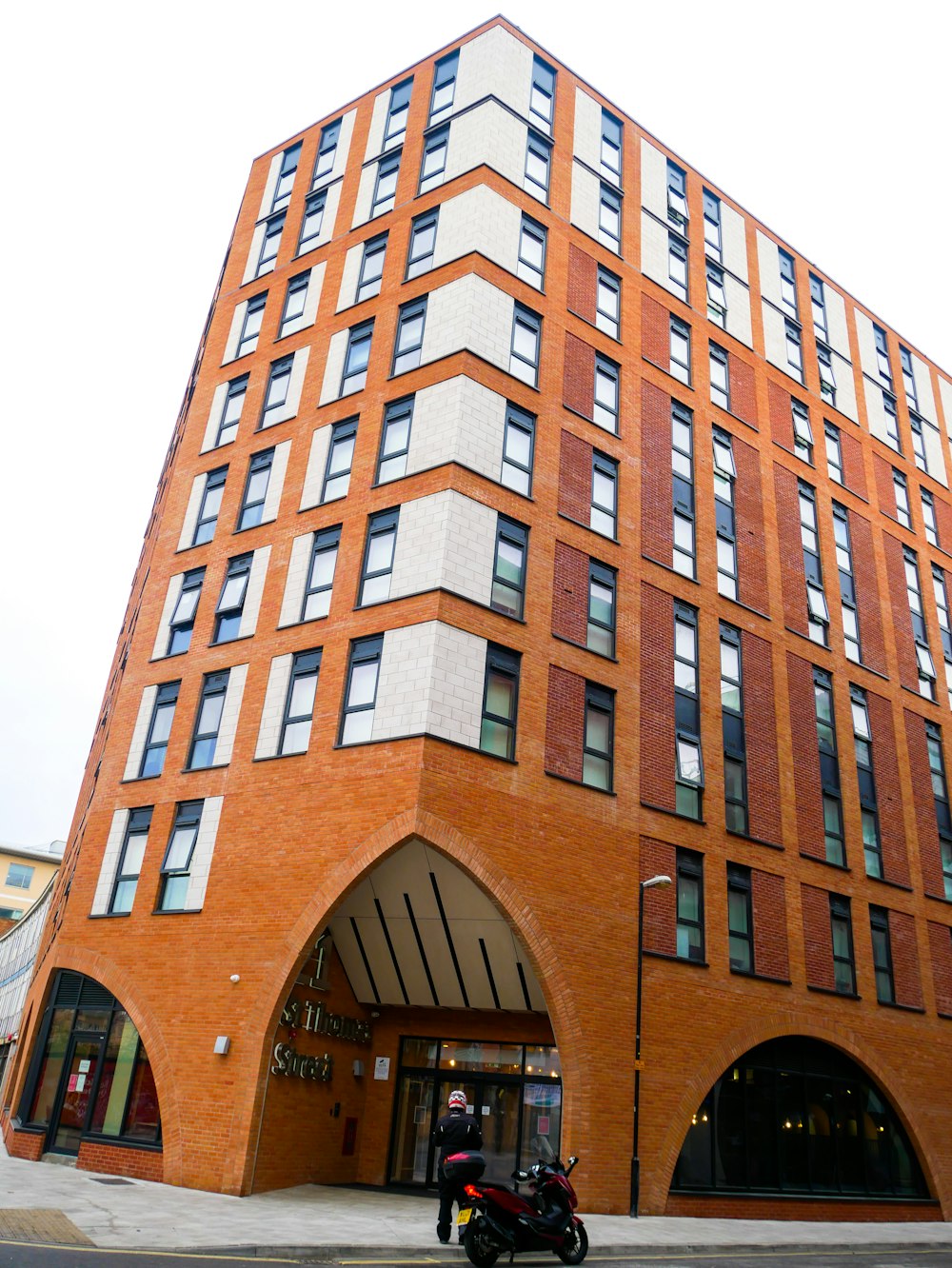 a motorcycle parked in front of a tall building