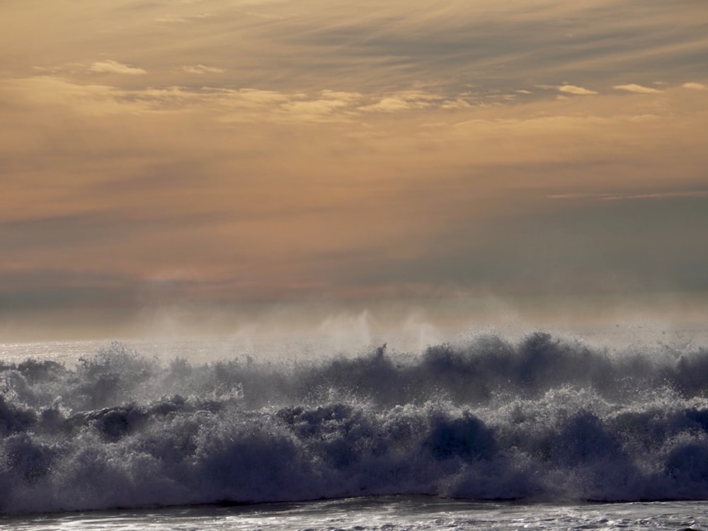 a man riding a surfboard on top of a wave in the ocean