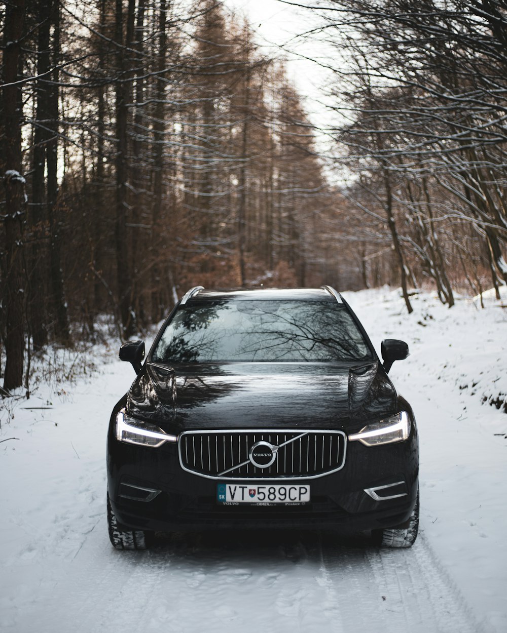 um carro volvo estacionado em uma estrada nevada