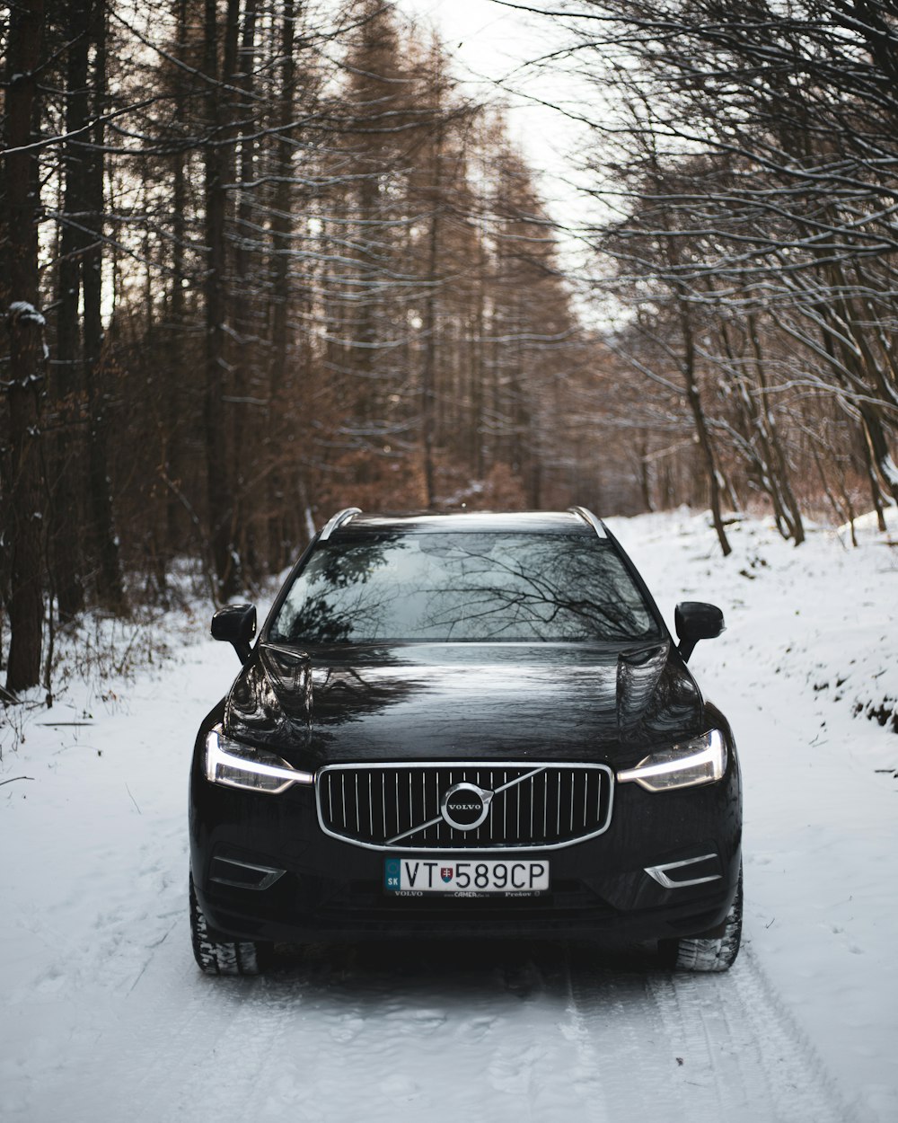 a volvo car parked on a snowy road