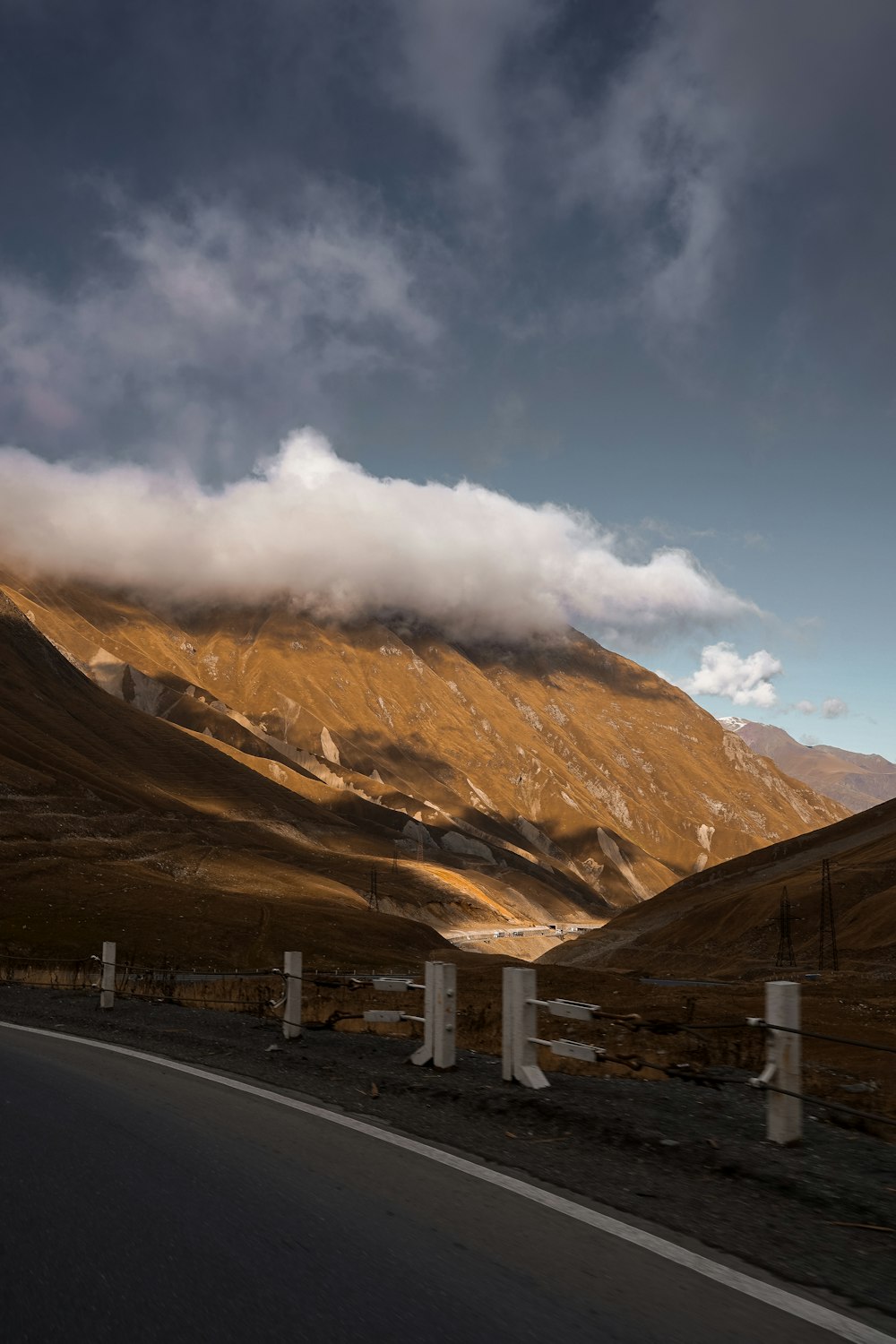 a road with a mountain in the background