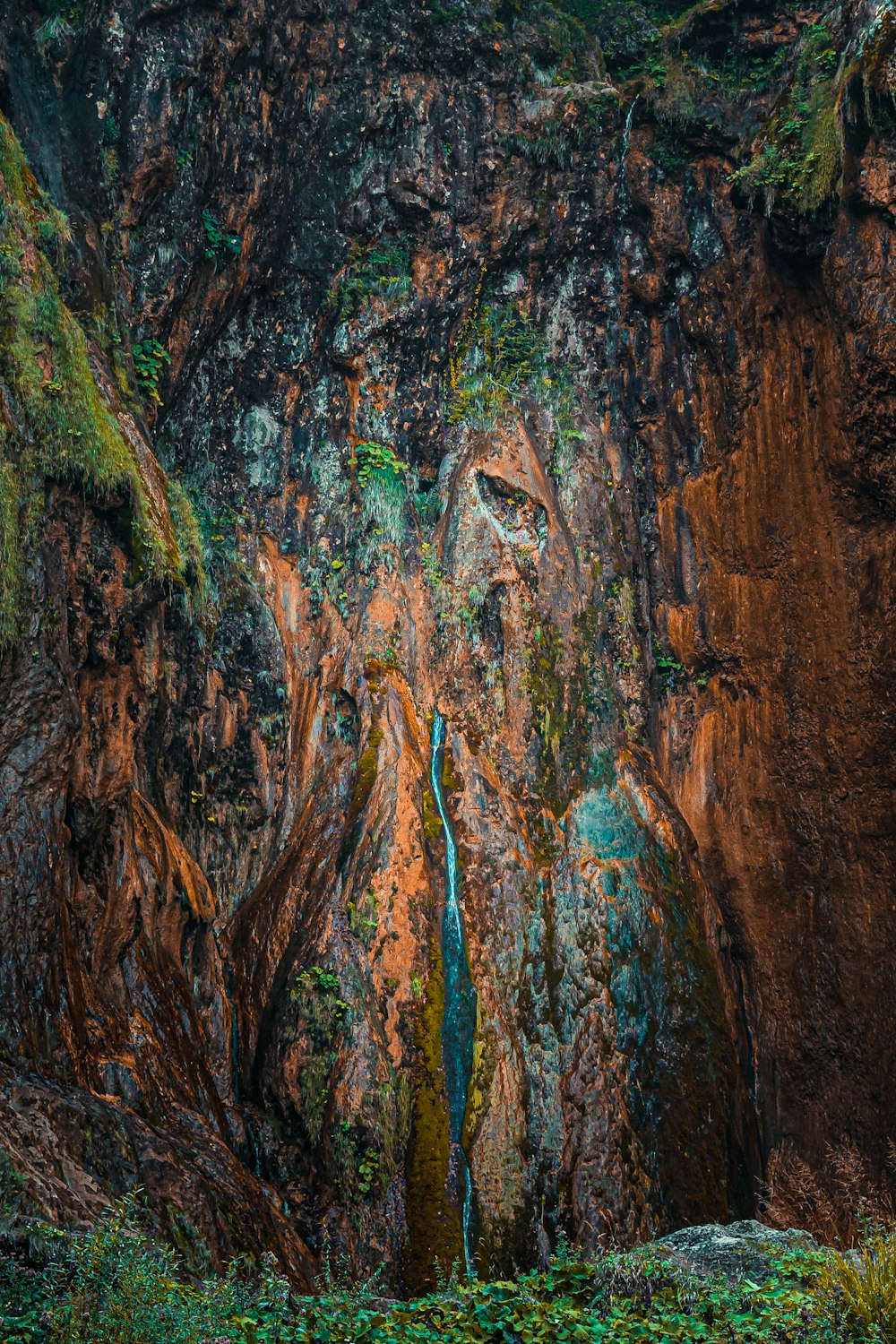 a waterfall in the middle of a rocky area