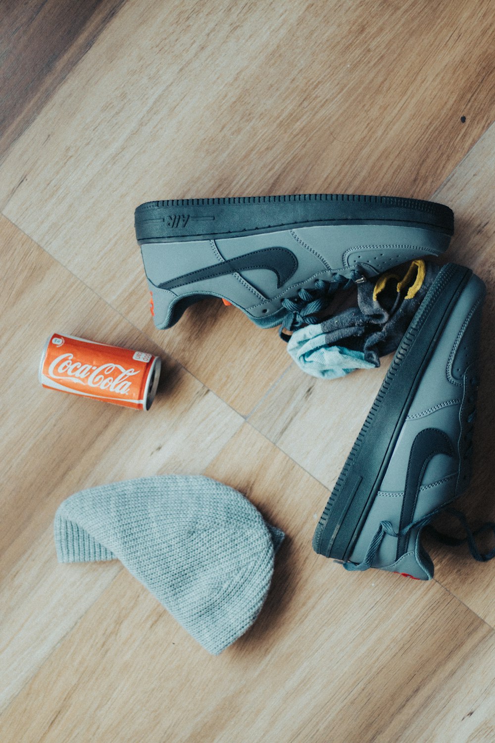 a pair of sneakers, a can of soda, and a pair of socks are