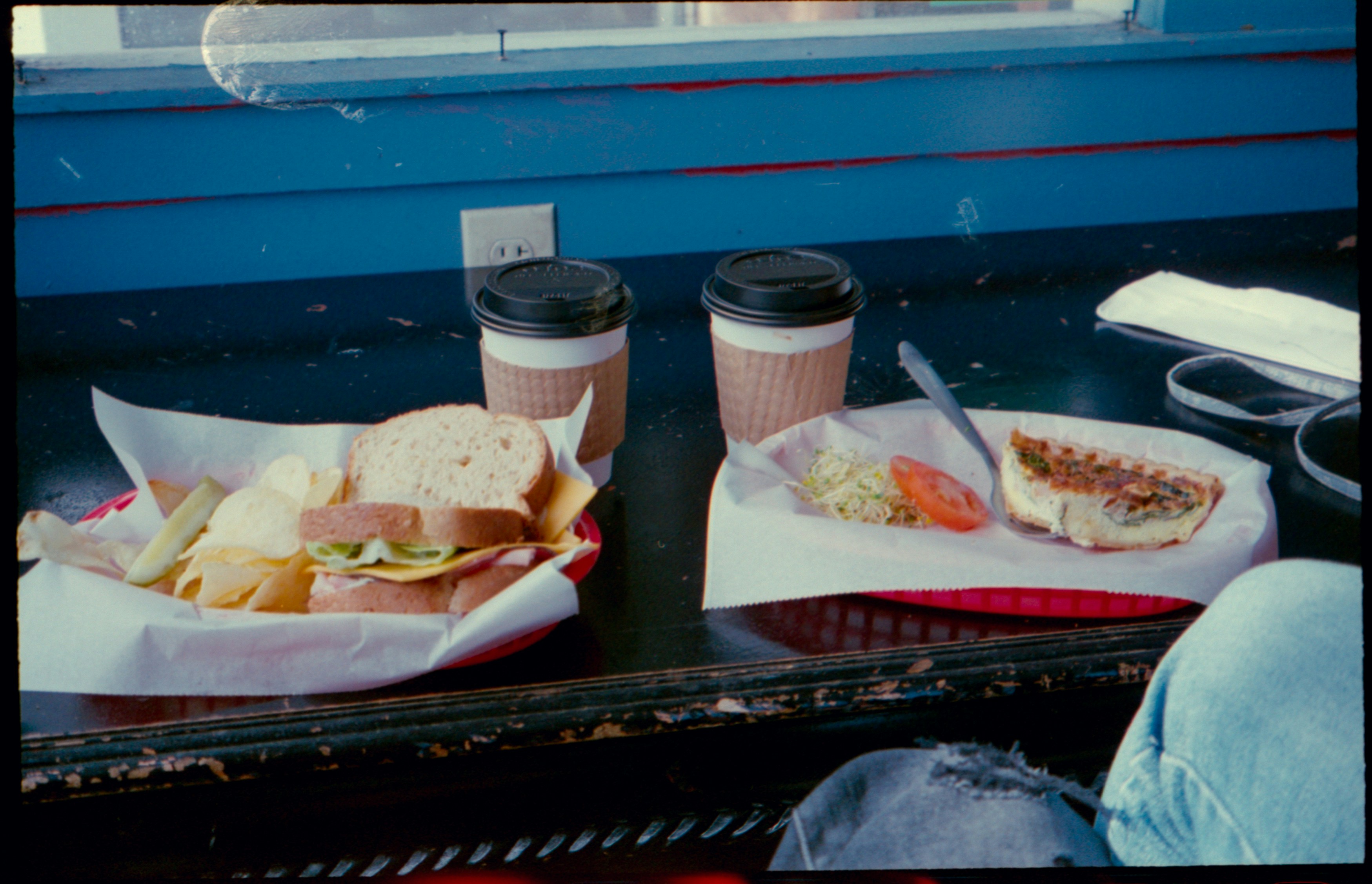a table topped with a sandwich and a cup of coffee