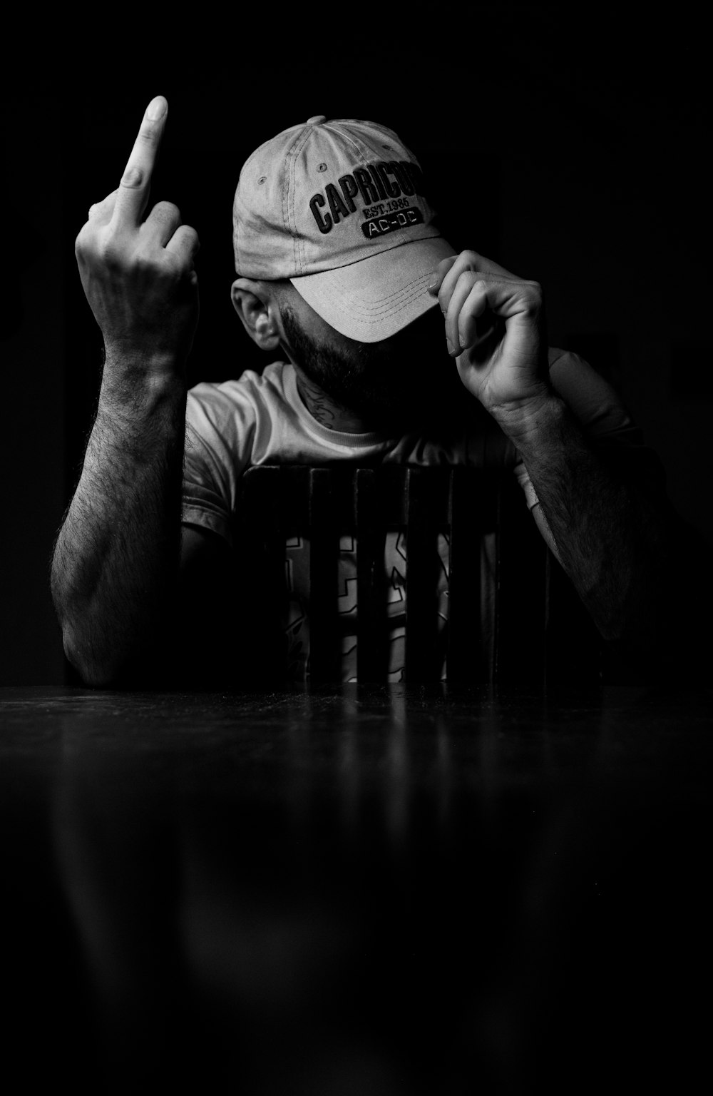 a black and white photo of a man wearing a hat