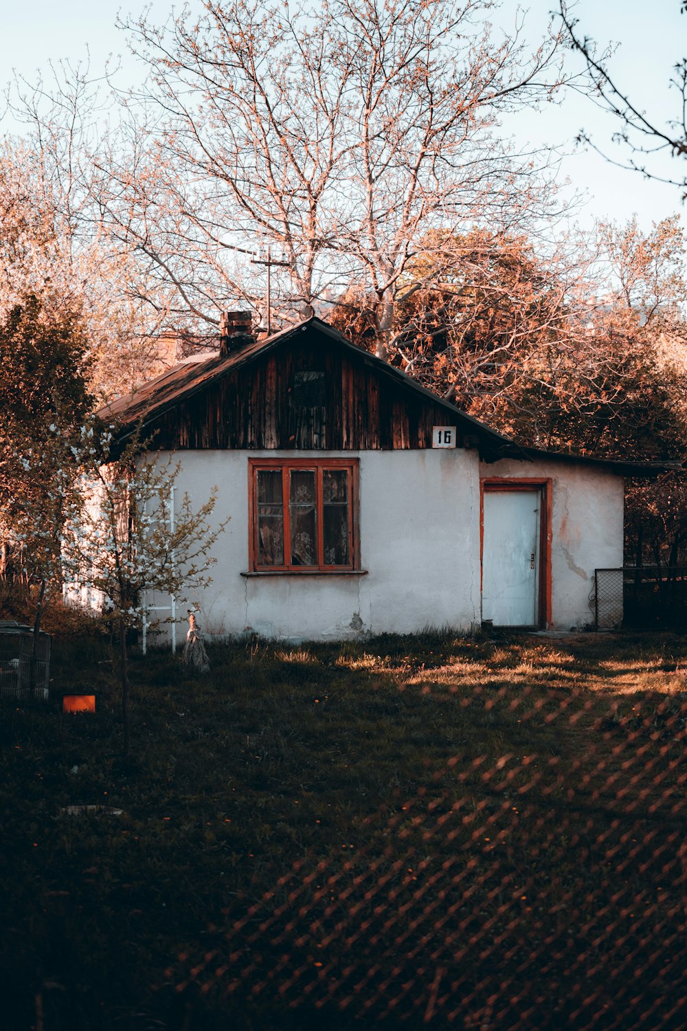 a small white house with a red door