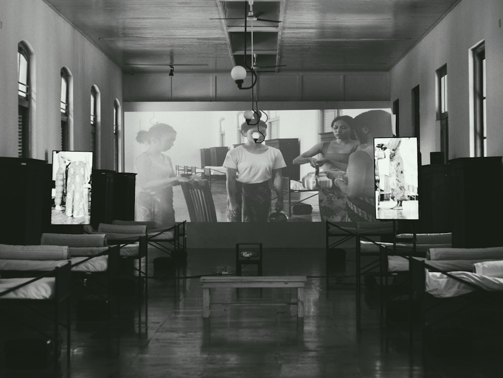 a black and white photo of people in a room