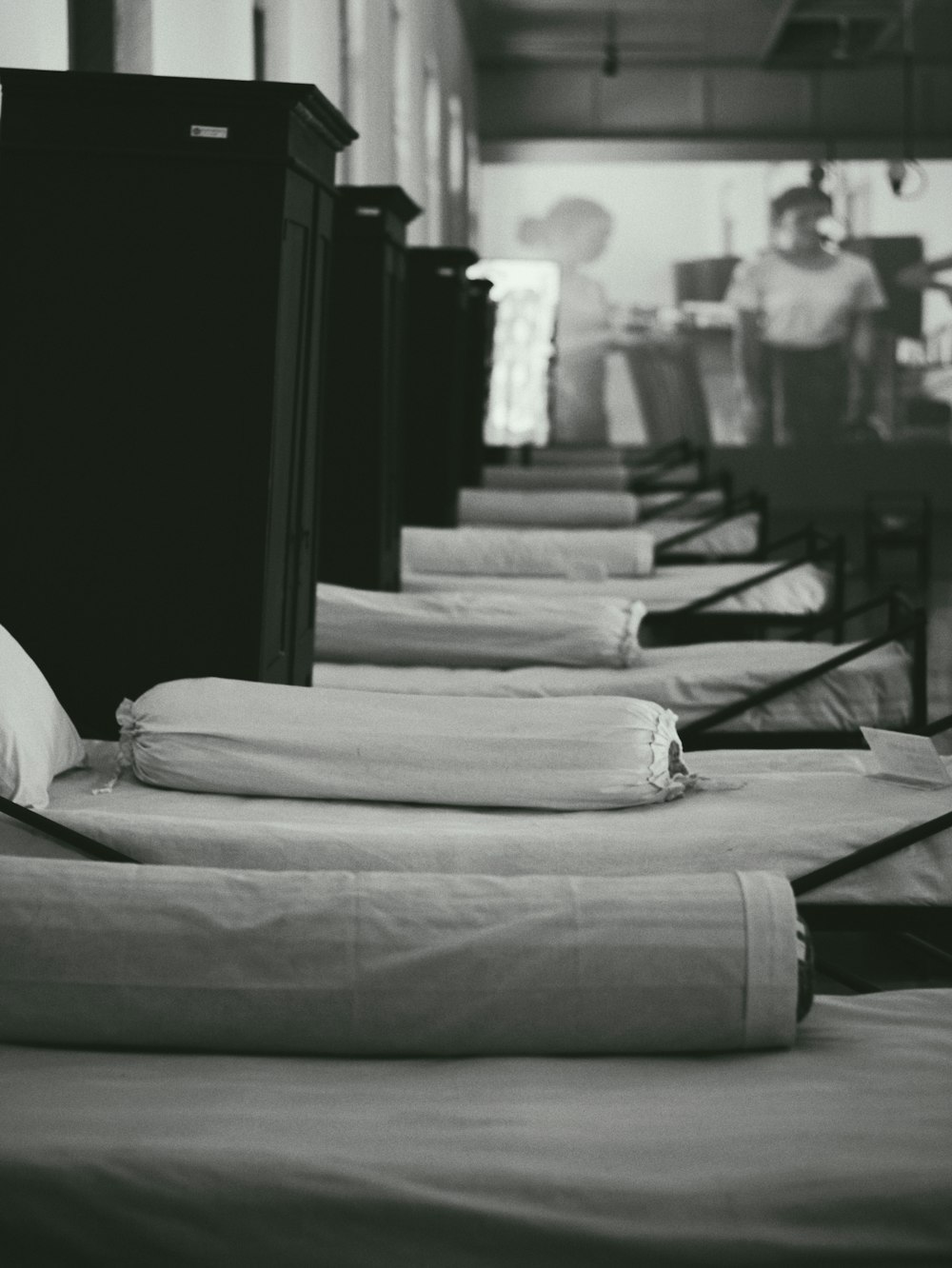a row of beds sitting next to each other in a room