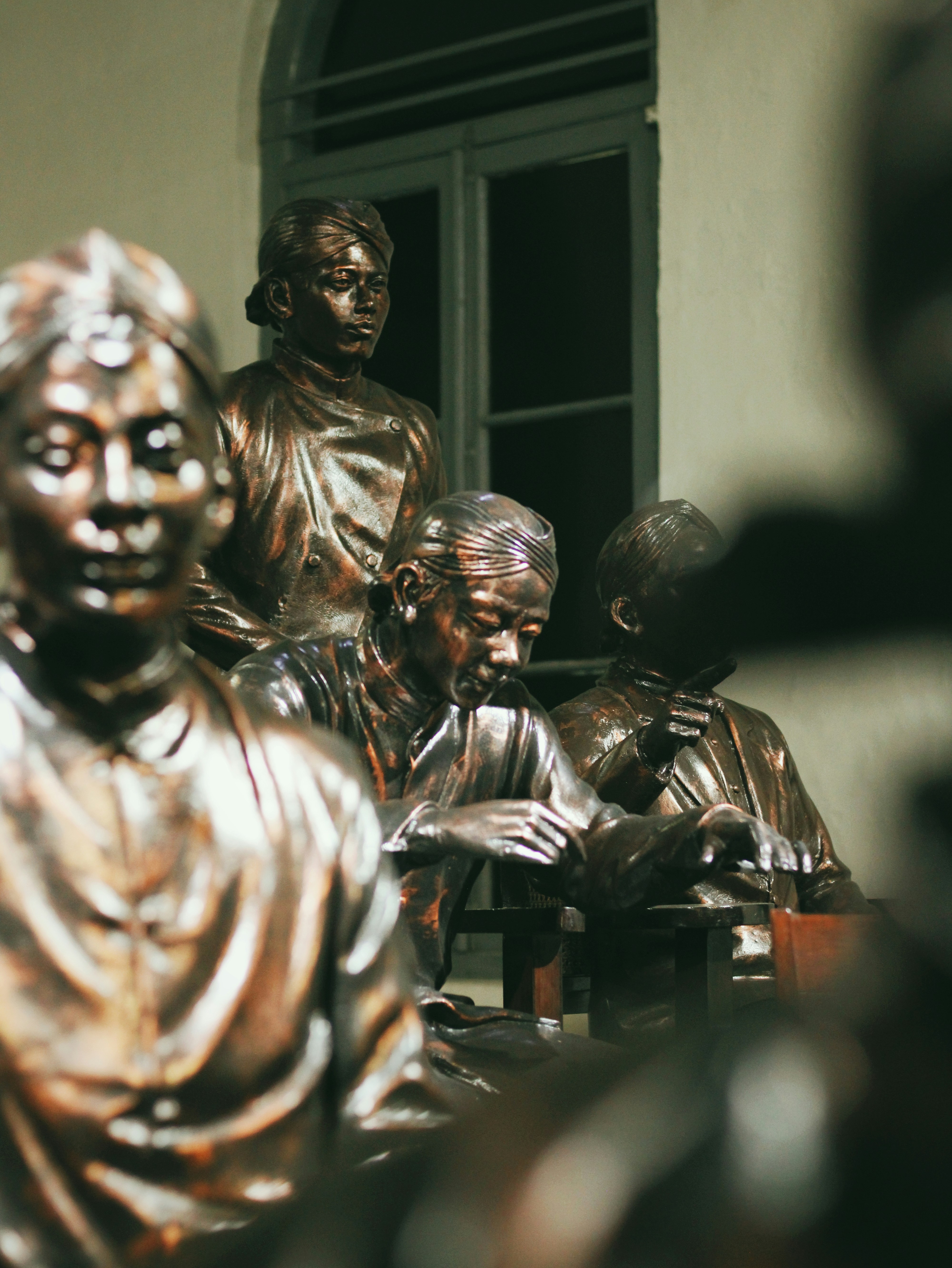 a group of bronze statues sitting next to each other