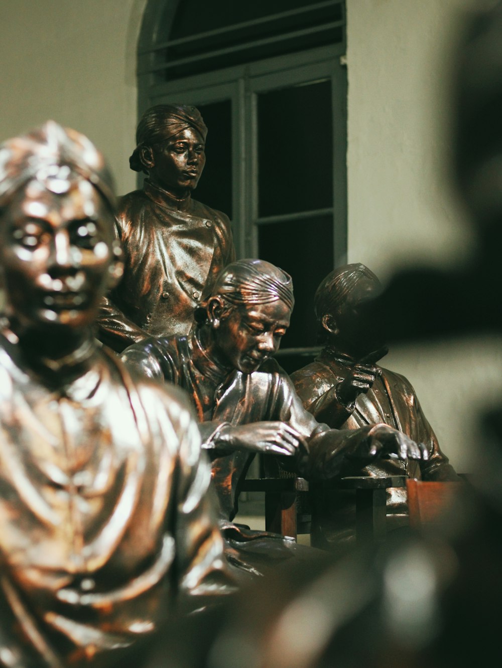 a group of bronze statues sitting next to each other