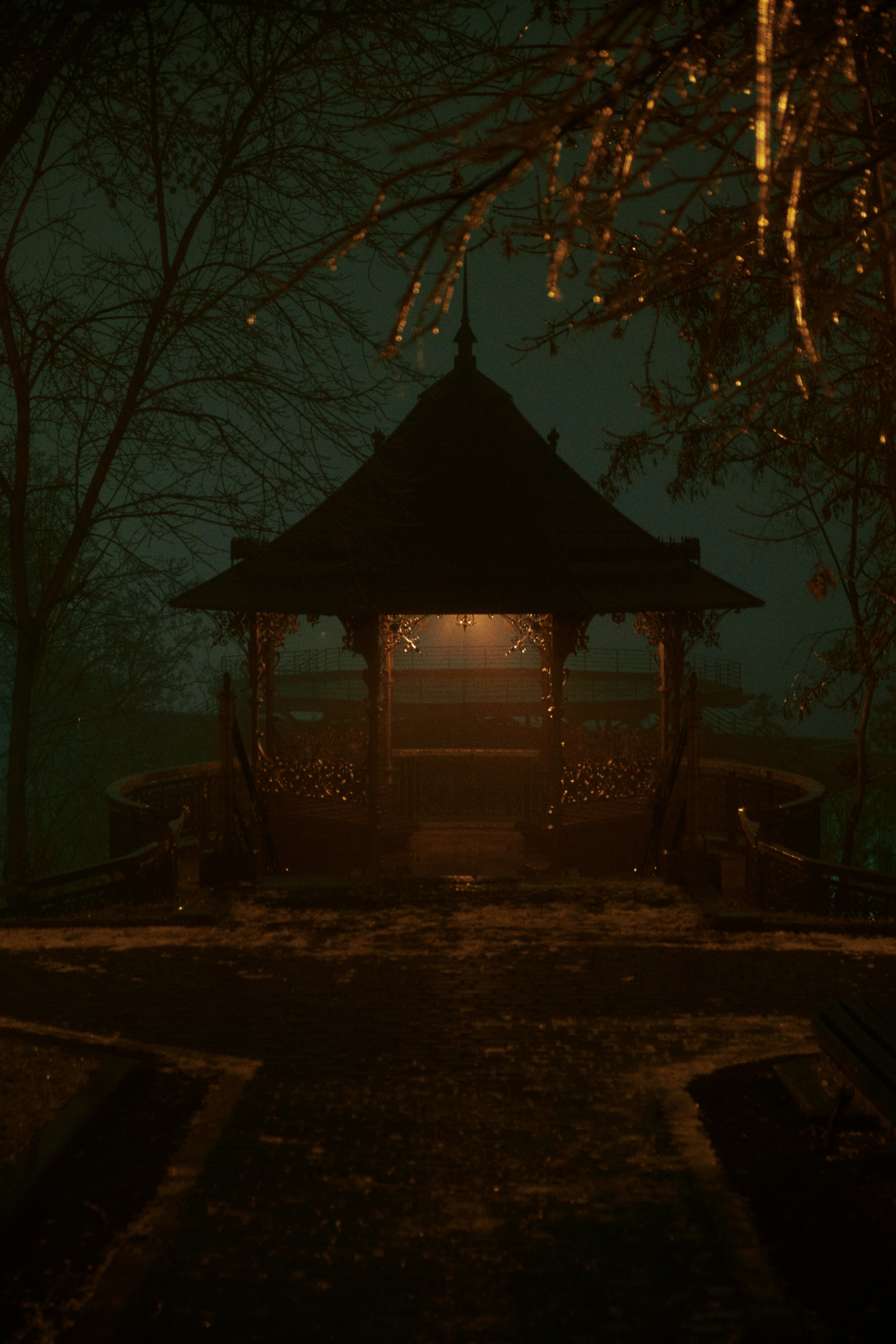 a gazebo in the middle of a park at night