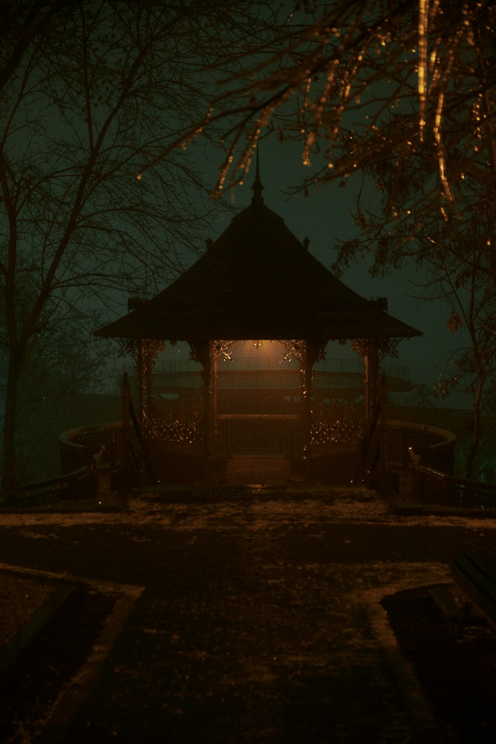a gazebo in the middle of a park at night