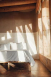 Sunlit bedroom featuring soft neutral tones and clean lines at Mimi Home Stay.