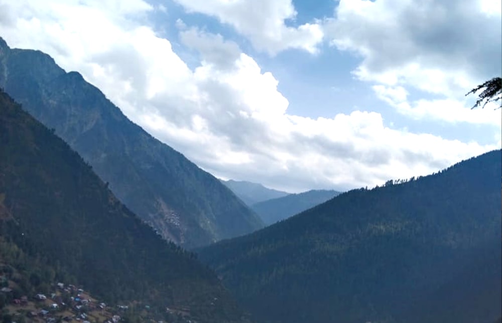 a view of a valley with mountains in the background