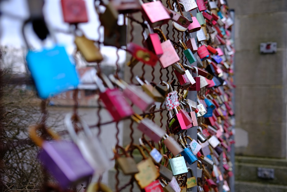 many padlocks are attached to a fence