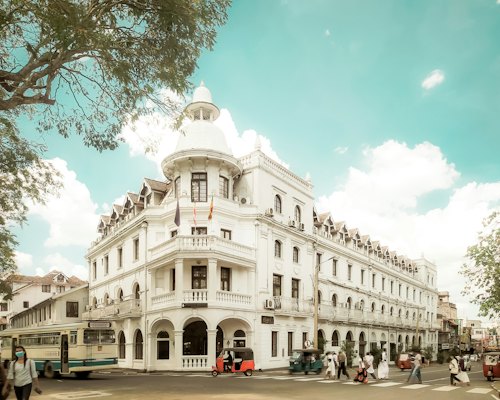 A large white building with a bus parked in front of it — Kandy, Sri Lanka