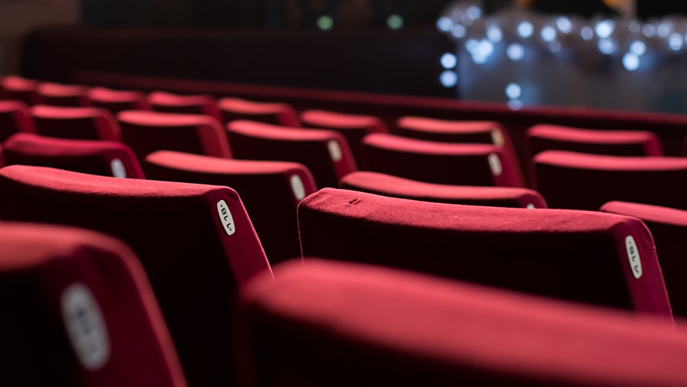 a row of red seats in a theater